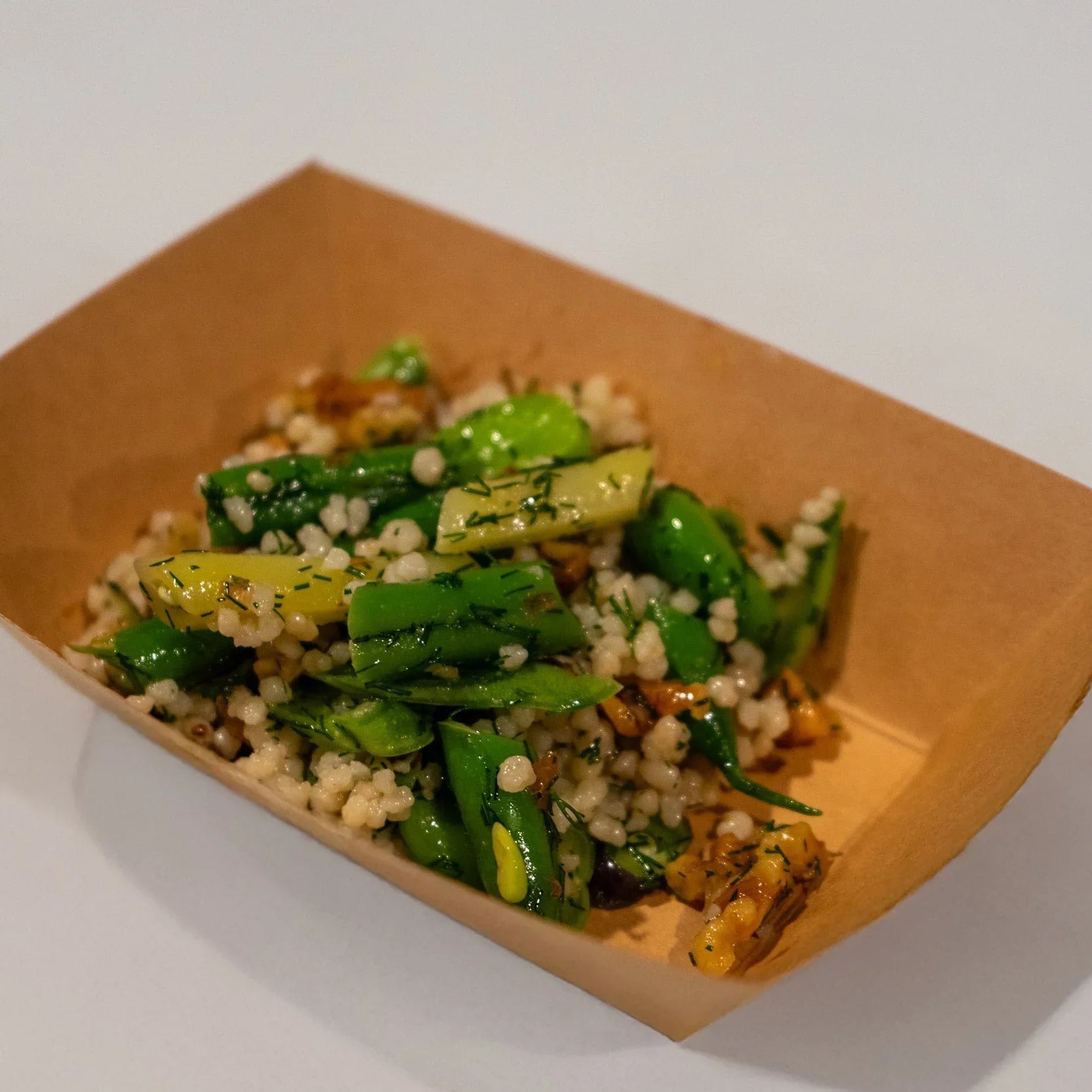Warm couscous salad with green beans, toasted walnuts, feta, and lots of dill