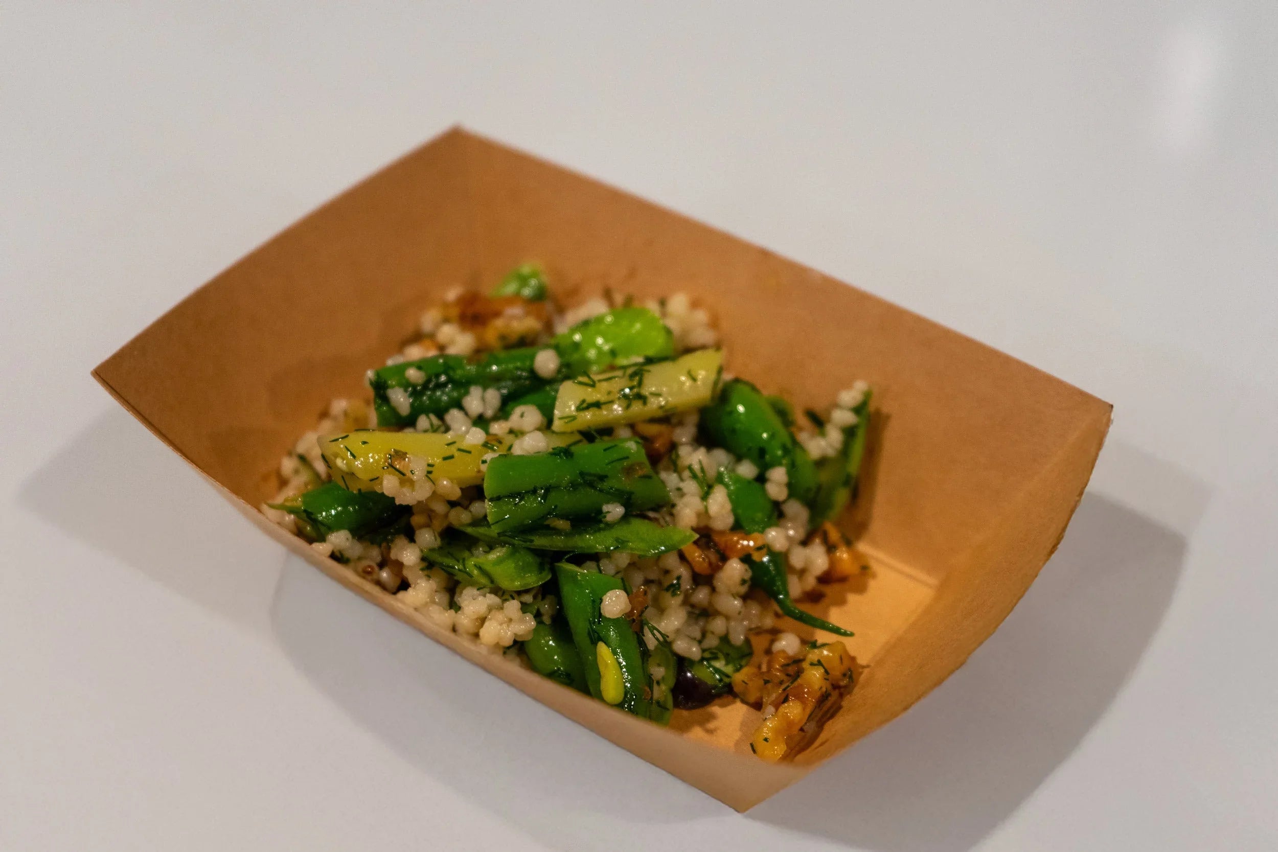 Warm couscous salad with green beans, toasted walnuts, feta, and lots of dill