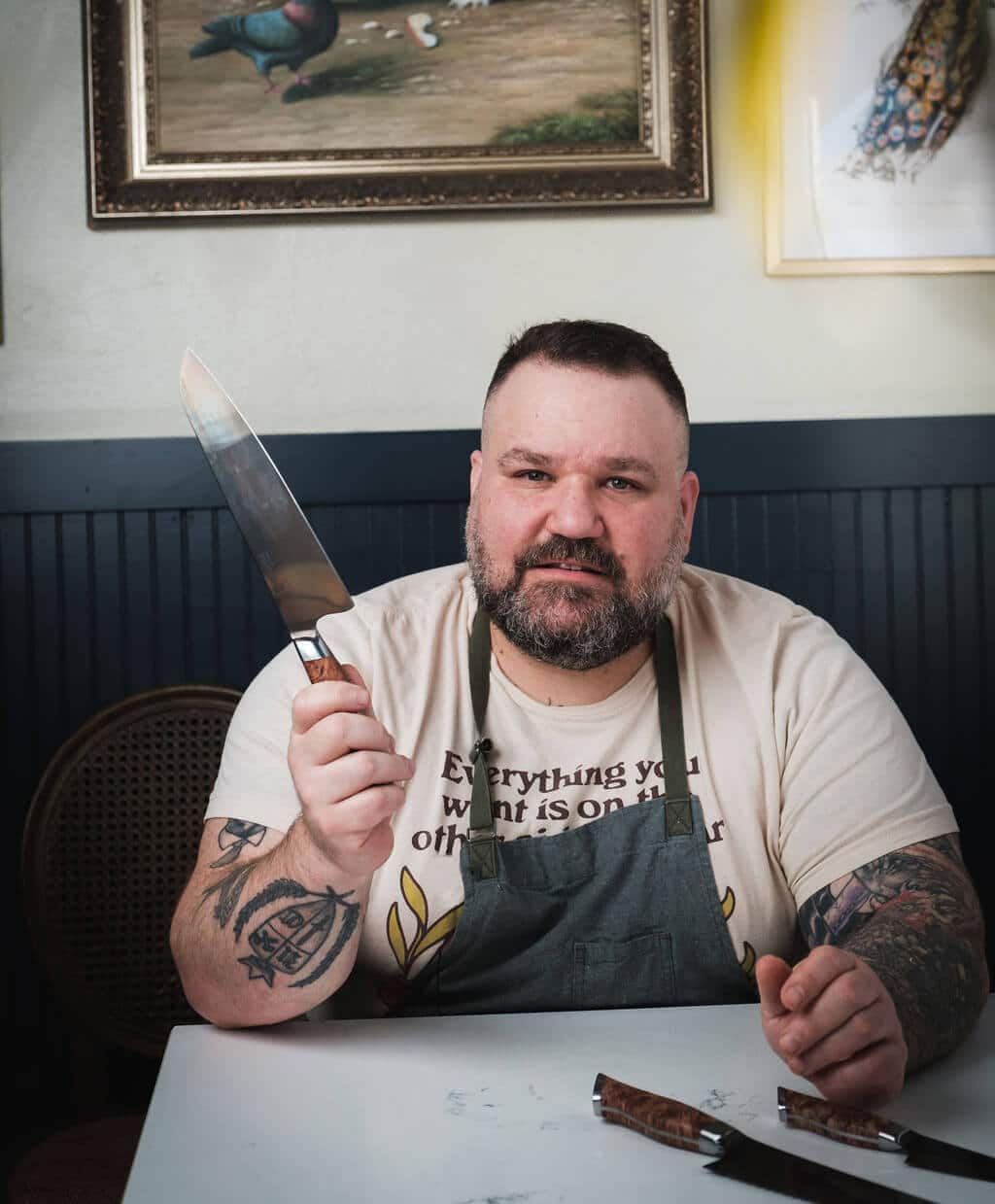 Chef Aaron Adams holding STEELPORT 8" Carbon Steel Chef Knife